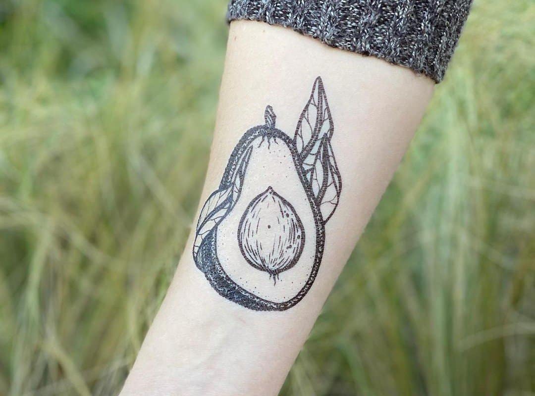 arm with a monochrome avocado tattoo