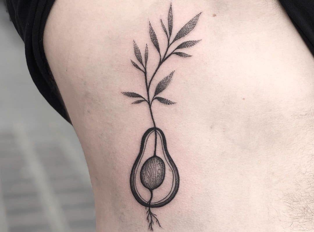 black and white tattoo of a sprouted avocado