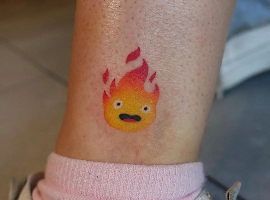 surprised calcifer tattoo on the leg