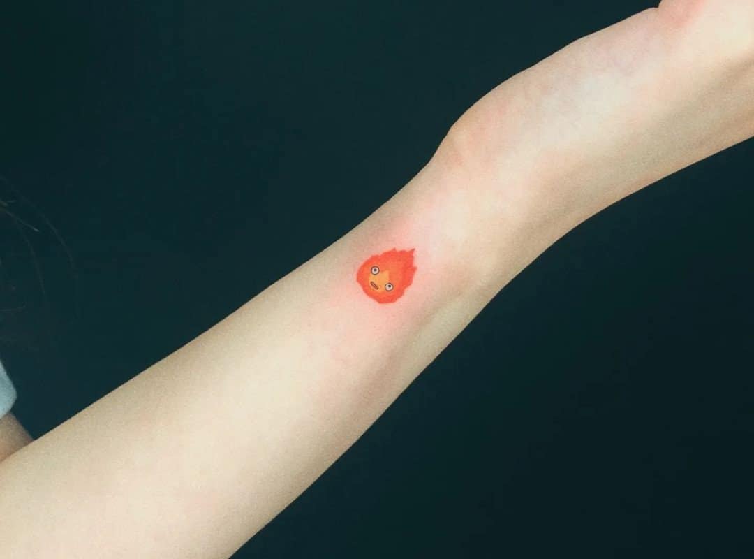 red calcifer tattoo on the wrist