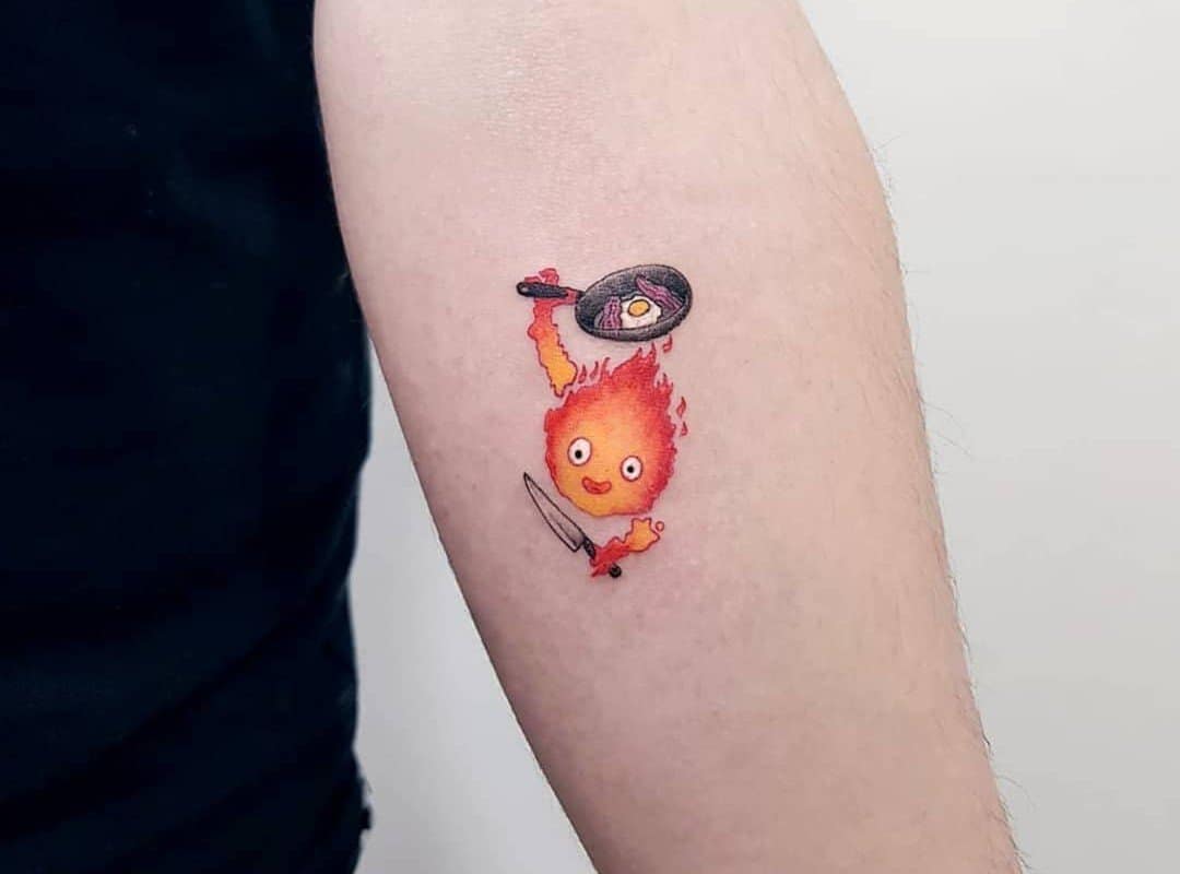 small calcifer tattoo with a frying pan