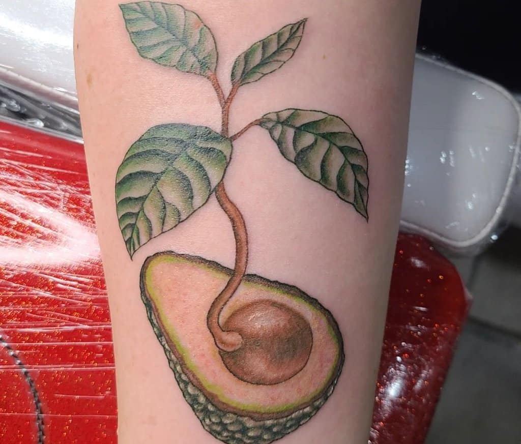 colored avacado tree tattoo on the leg