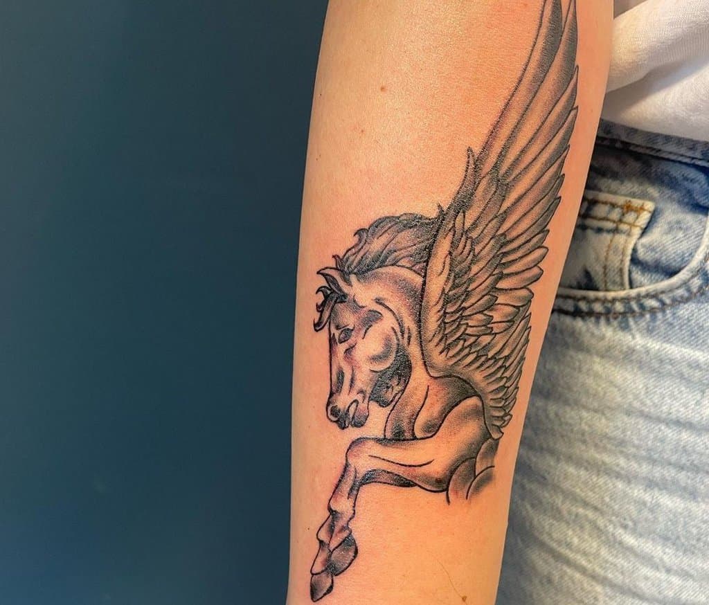 monochrome pegasus tattoo on the forearm