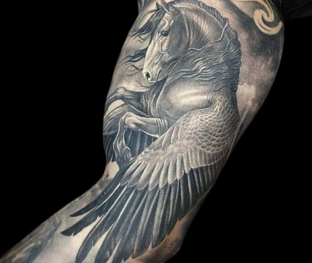 monochrome pegasus tattoo on the biceps