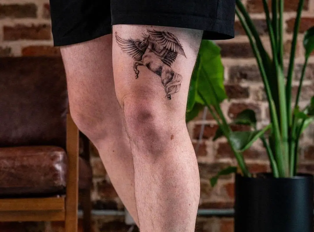 monochrome pegasus tattoo on the thigh