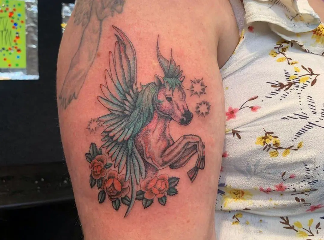 a beautiful tattoo of a pegasus in flowers