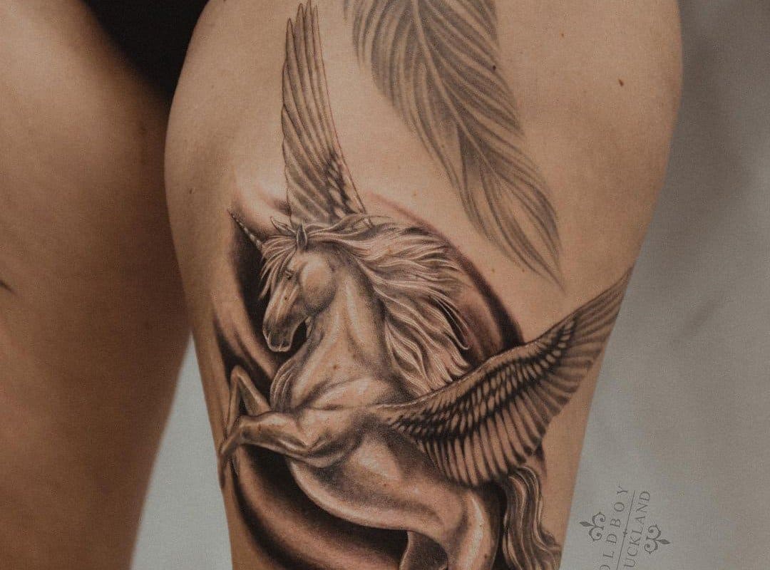 A realistic tattoo of a pegasus on a girl's thigh