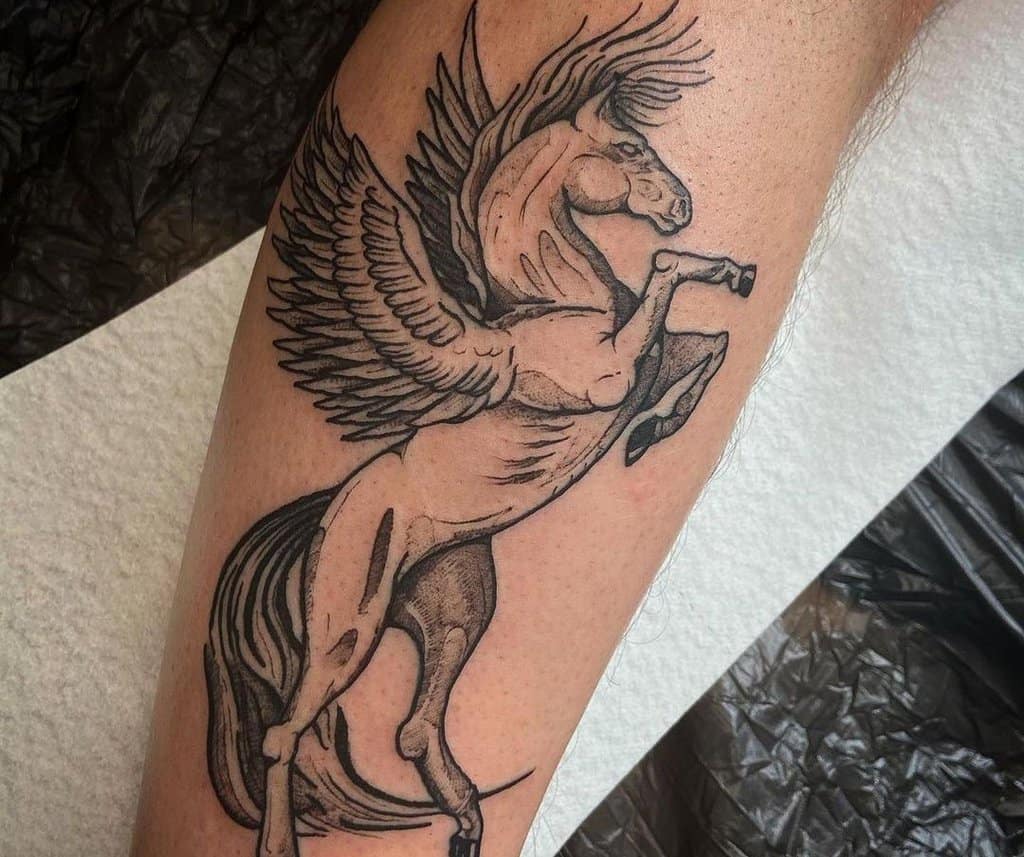 A tattoo of a pegasus standing on an end