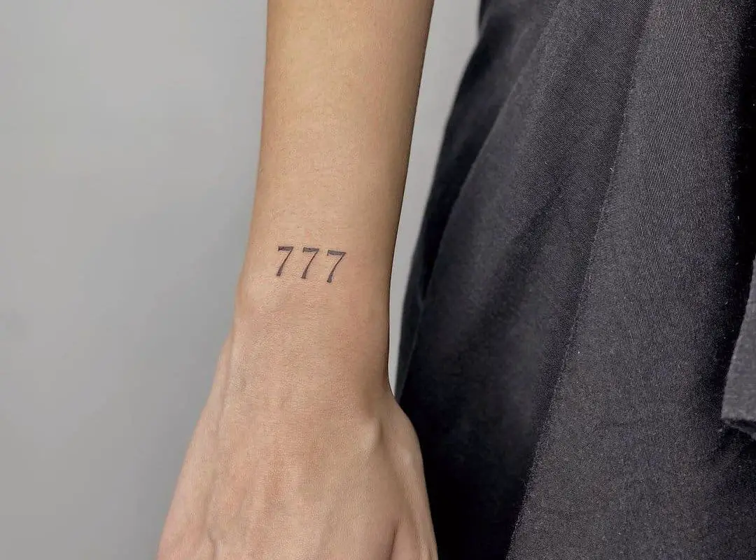 three sevens tattoo on the wrist