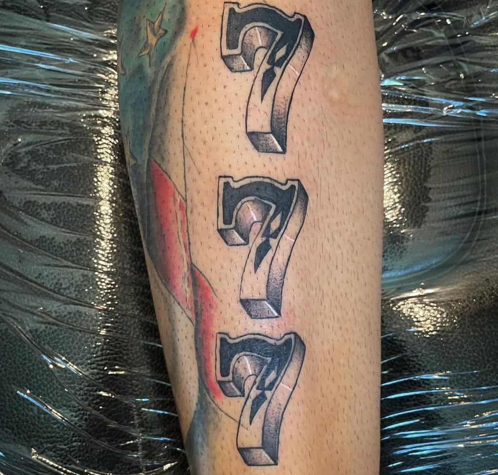 three sevens tattoo on top of each other