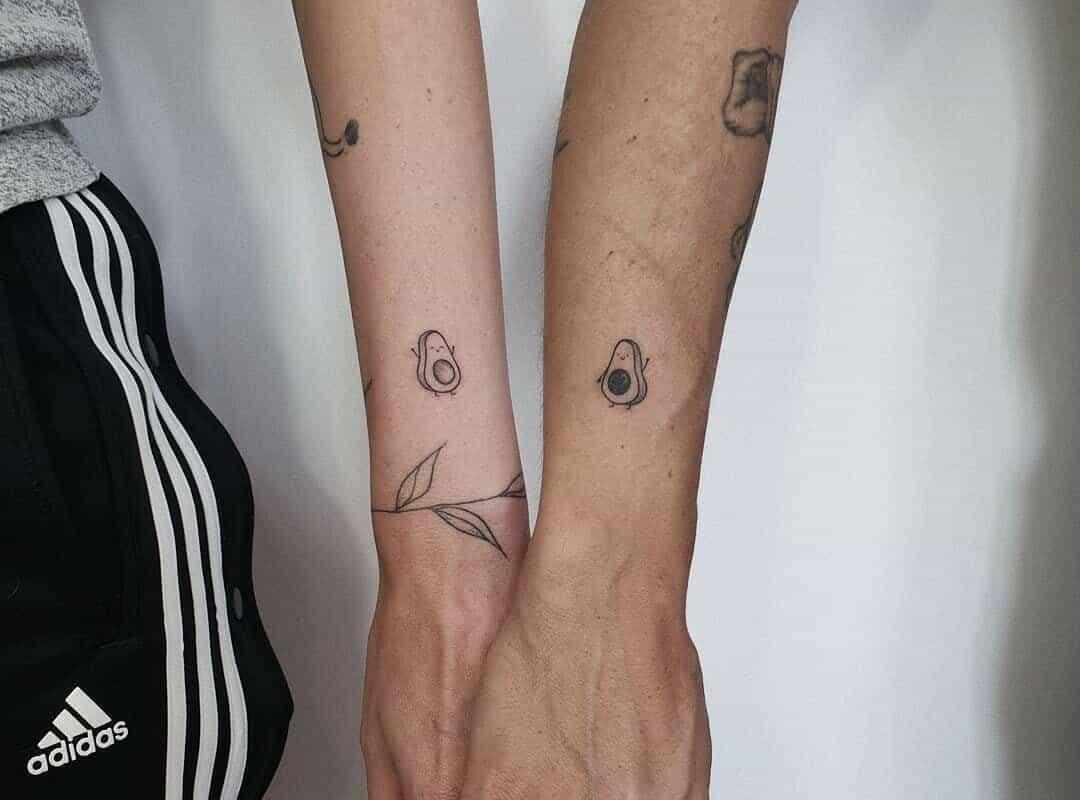 Avocado tattoos on the hand of friends
