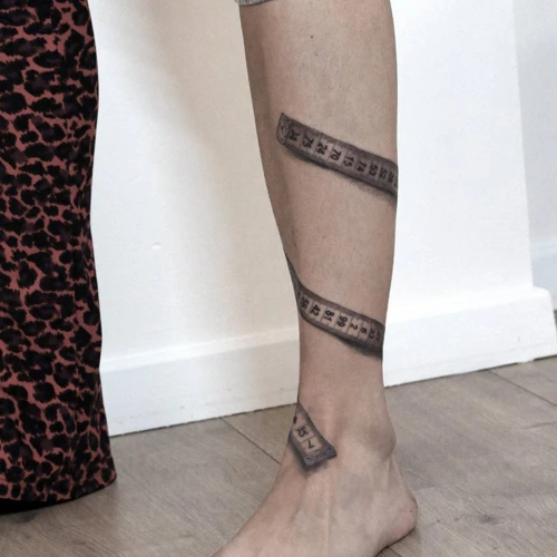 Measuring A Tattoo With A Measuring Tape